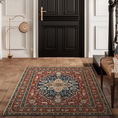 an ornate rug in front of a black door