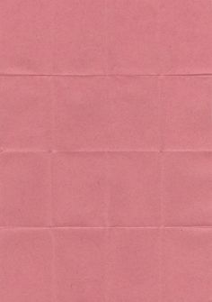 a piece of pink colored paper with some writing on the bottom and one corner missing