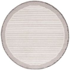 a round rug with white and grey stripes