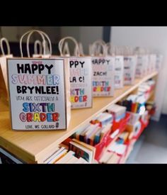 some bags are sitting on a shelf in front of the sign that says happy summer bpynlee