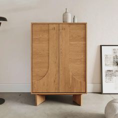 a wooden cabinet sitting in the middle of a room