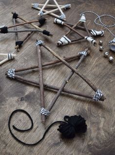 an assortment of wooden sticks and other items on a wood floor, including necklaces