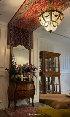 an ornately decorated room with a chandelier hanging from the ceiling