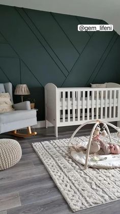 a baby laying in a white crib on top of a rug next to a rocking chair