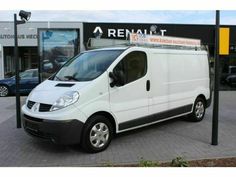 a white van parked in front of a building