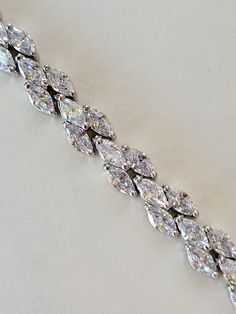 "Hello, welcome to Ken's Closet Today we have a beautiful CZ Diamond Bracelet. This is very sparkly. This bracelet is in a silver setting. Diamonds are AAA Certified and sparkle beautifully. We offer this style in 2 different sizes. - 6\" - 7\"" Silver Diamond Cut Bracelet For Party, Silver Sparkling Tennis Bracelet For Anniversary, Dazzling Cubic Zirconia Crystal Bracelet, Party Silver Diamond Cut Bracelet, Silver Sparkling Diamond Bracelet, Sparkling Silver Diamond Bracelet With Dazzling Style, Silver Cubic Zirconia Sparkling Tennis Bracelet, Dazzling Silver Diamond Bracelet Sparkling, Silver Sparkling Cubic Zirconia Tennis Bracelet