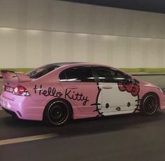 a pink car with hello kitty painted on it