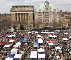 an aerial view of the city with tents set up in front of buildings and people walking around