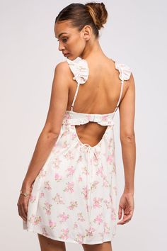 Throw on the Lulu White and Pink Floral Ruffle Mini Dress for your next country concert or trip to Nashville! White, pink and green floral fabric shapes this bustier babydoll dress with ruffle straps and a cutout back. Features ruffle trim at the bust. Style with cowboy boots for a cute and fun look! DETAILS & FIT Hits at Upper Thigh. Flowy Silhouette. Rayon. Lining: Polyester. Machine Wash Cold. Imported. Flowy Mini Dress Lulus, Cheap Flowy Mini Dress With Ruffles, Spring Flower Dress Pink, Pink Ruffle Floral Mini Dress, White And Green Floral Mini Dress, Cheap Bohemian Mini Dress With Ruffles, Cowuette Floral Mini Dress, Cheap Pink Bohemian Mini Dress, Spring White Floral Dress