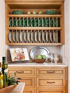 a wooden cabinet filled with dishes and plates