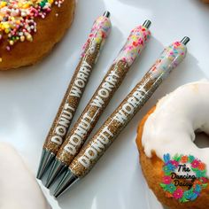 three donuts are sitting next to each other on a white plate with confetti