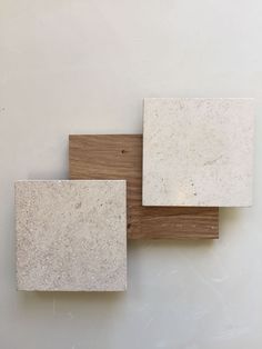 three white and brown square tiles sitting on top of each other