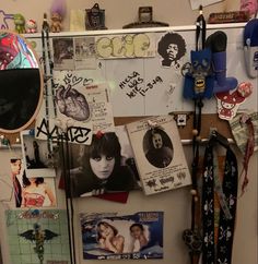 a refrigerator covered in pictures and magnets next to a wall with posters on it