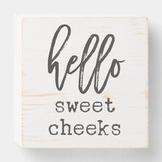 a wooden block with the words hello sweet cheeks written in cursive writing on it