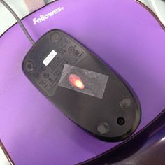 a computer mouse sitting on top of a purple pad with the word fellowwees written on it