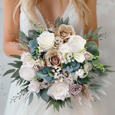 a bridal holding a bouquet of flowers and greenery