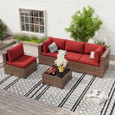 an outdoor living room with red couches and chairs