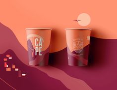 two coffee cups sitting side by side on a pink and orange background with mountains in the background