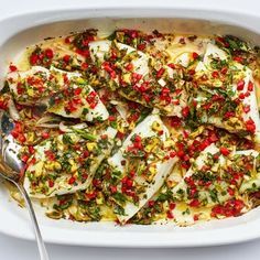 a casserole dish with fish and vegetables in it, ready to be eaten