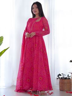 Introducing our stunning pink bandhani printed chiffon gown with dupatta, the perfect outfit for any festive occasion! This beautiful pink gown features intricate bandhani print work, giving it a traditional yet elegant look. The chiffon material adds a touch of sophistication, making you stand out at any event.
This gorgeous gown include its fully stitched design, making it hassle-free to wear. The matching chiffon dupatta with bandhani print work and fancy lace work adds an extra touch of glam Silk Anarkali Gown, Bandhani Suit, Flair Gown, Chiffon Anarkali, Gotapatti Work, Bandhej Print, Kurti Sets, Gown With Dupatta, Lehenga Choli Wedding