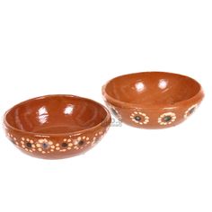 two brown bowls sitting next to each other