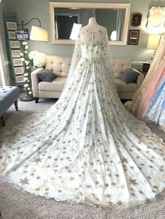 a wedding dress on display in a room with other dresses and accessories around it,