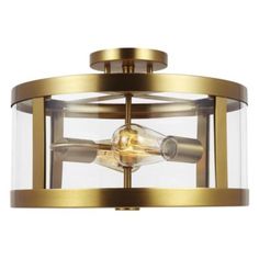 an image of a flush light fixture with clear glass on the bottom and gold trim