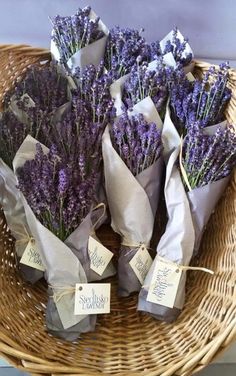 bunches of lavender flowers in a wicker basket with price tags on the handles