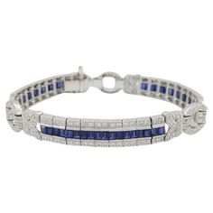 Introducing an exquisite piece of timeless elegance: behold our Authentic Vintage 18K White Gold Bracelet adorned with a captivating combination of Round Brilliant Diamonds and Blue Sapphires. Crafted to perfection, this bracelet boasts a total of 248 Round Brilliant Cut Diamonds, adding up to approximately 1.86 carats in weight. These diamonds, ranging from F to H in color and exhibiting VS to SI clarity, shimmer with unparalleled brilliance. Complementing the diamonds are 25 natural straight baguette Blue Sapphires, totaling approximately 4.5 carats. Their deep, rich hue adds a touch of sophistication to the ensemble. With a weight of 27.1 grams and dimensions measuring 7 inches long, 8-10 mm wide, and 2.9 mm thick, this bracelet effortlessly combines luxury with comfort. Each detail of Gold Armband, White Gold Bracelet, Sapphire Bracelet, Fine Jewels, Timeless Treasures, Round Brilliant Cut Diamond, Vintage Charms, Round Brilliant, Blue Sapphire