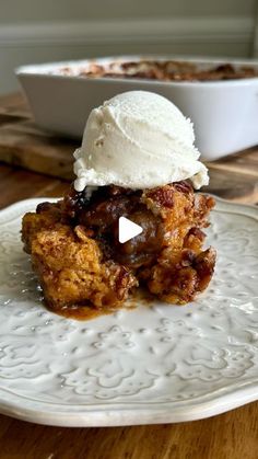 a white plate topped with two desserts on top of a wooden table next to a bowl of ice cream