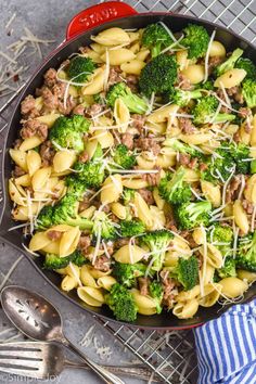 a skillet filled with pasta and broccoli