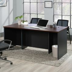 an office desk with a laptop on it