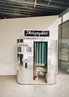 an old fashioned photo booth in the middle of a building