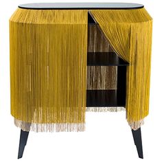 the sideboard is decorated with yellow and black fringes