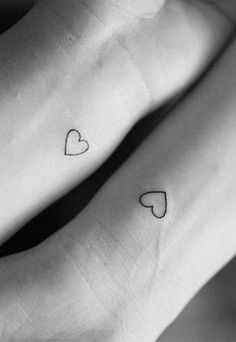 two small heart tattoos on both wrist