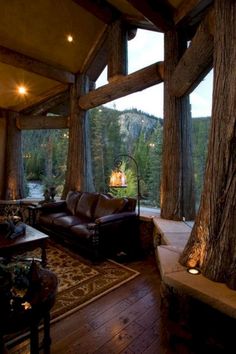 a living room filled with furniture next to a large window covered in wood planks