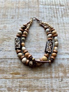 Made with agate, metal, and wood beads. Measures roughly 8.5 inches. Ice Cream Shoes, Medicine Pouch, Bronze Bracelet, Double Bracelet, Bracelets Men, Bronze Bracelets, Card Purse, Wood Bracelet, Agate Bracelet