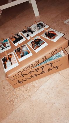 an open box with pictures on it sitting on the floor