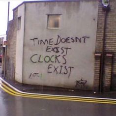 graffiti on the side of a building that says time doesn't east clocks exit