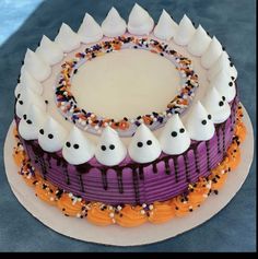 a halloween cake with white frosting and sprinkles on it's edges