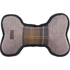 a brown and black dog bone pillow with a checkered pattern on the front side