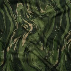 a green and black marble pattern on fabric