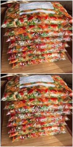 several bags of food sitting on top of a wooden table covered in plastic wrappers