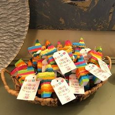 a basket filled with lots of colorful pieces of paper