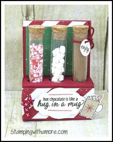 three bottles filled with hot chocolate and marshmallows in front of a christmas card