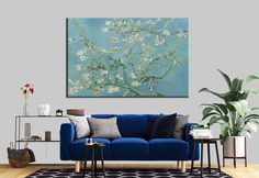 a living room with a blue couch and painting on the wall