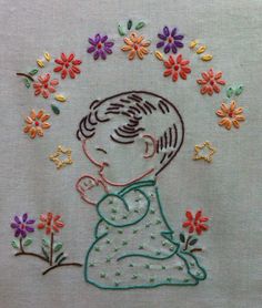 a child with flowers on it's head is embroidered onto the back of a t - shirt