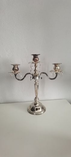 a silver candelabra with five candles on it