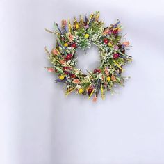 a wreath made out of fake flowers on a wall