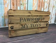 a wooden crate with paws off my toys written on it